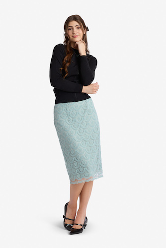 Woman wearing a black long sleeve top and a light blue lace skirt