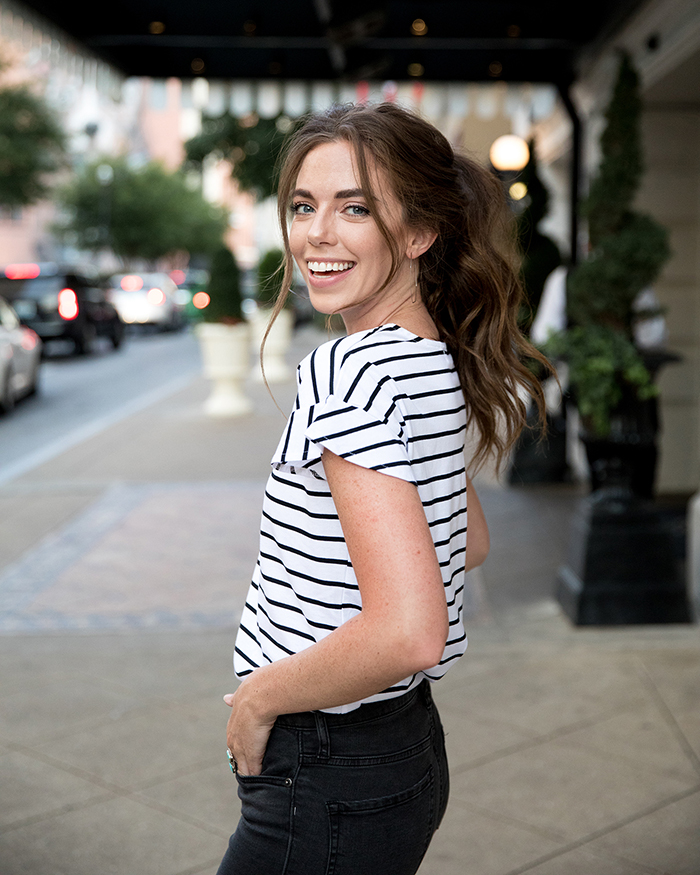 Woman smiling wearing striped shirt