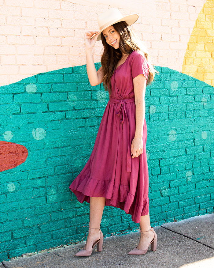 Young woman wearing a pink wrap bridesmaid dress