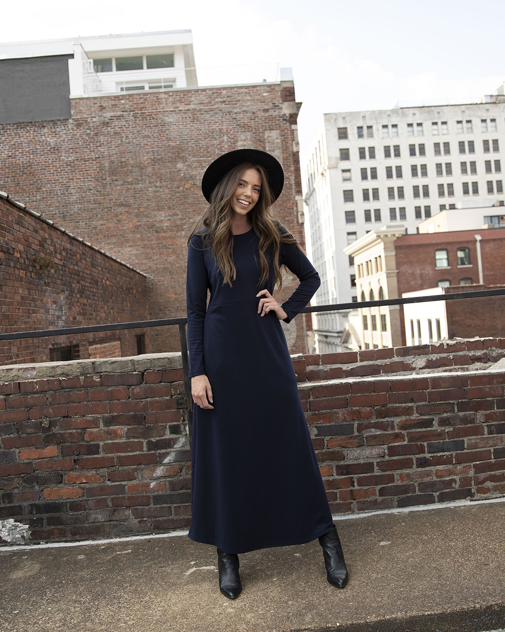 Woman in black hat and Navy Maxi Dress