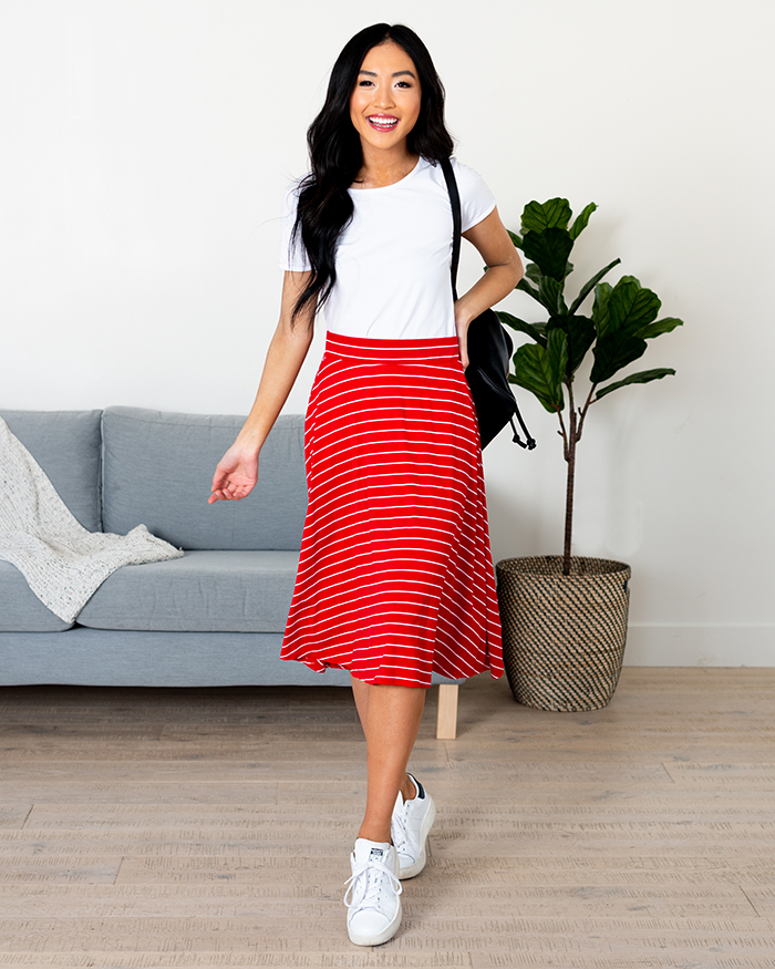 Woman in red and white stripe midi skirt
