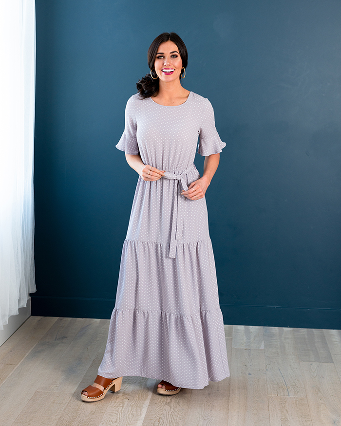 Young woman wearing a gray maxi bridesmaid dress