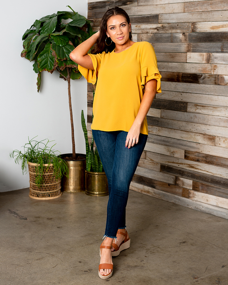 Woman in yellow bell sleeve shirt