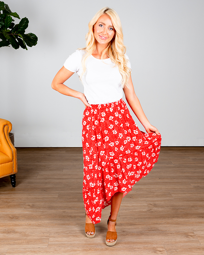woman in high-low red floral skirt