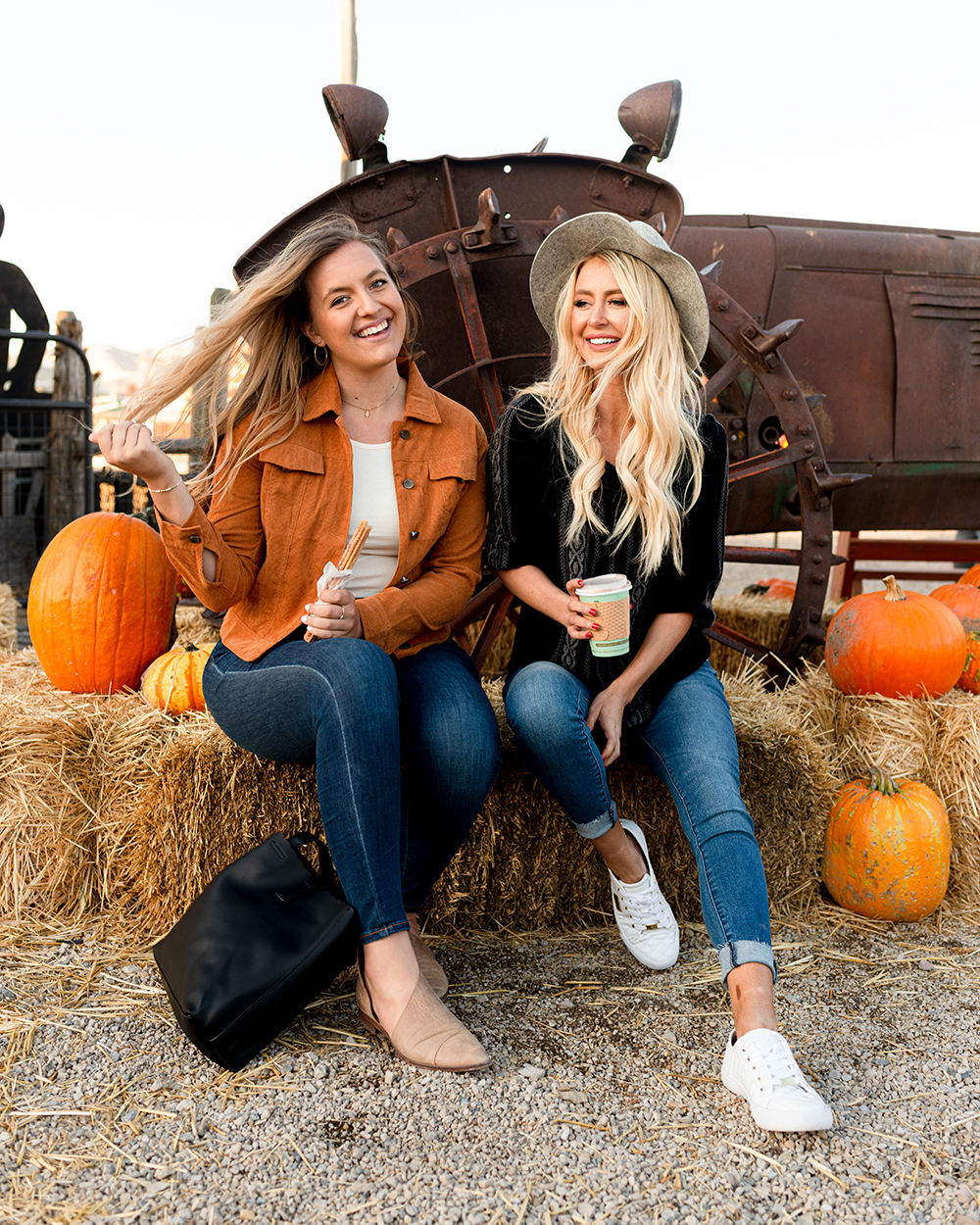 2 women in a pumpkin patch wearing modest clothing.