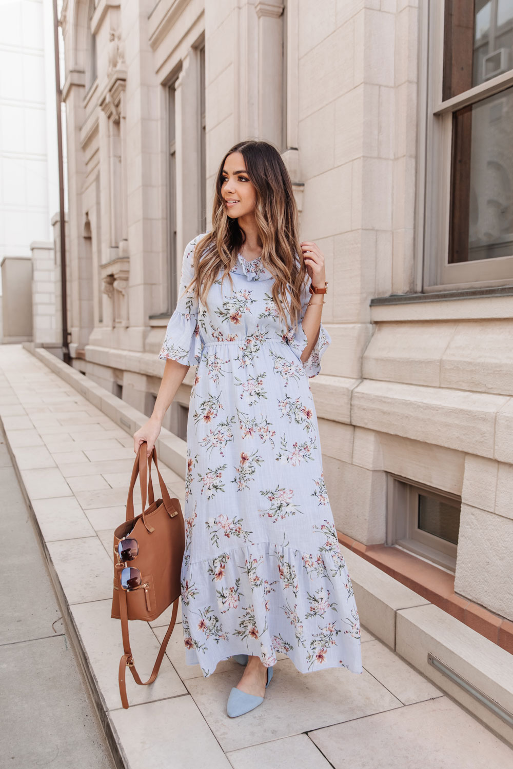 Woman in blue floral maxi dress