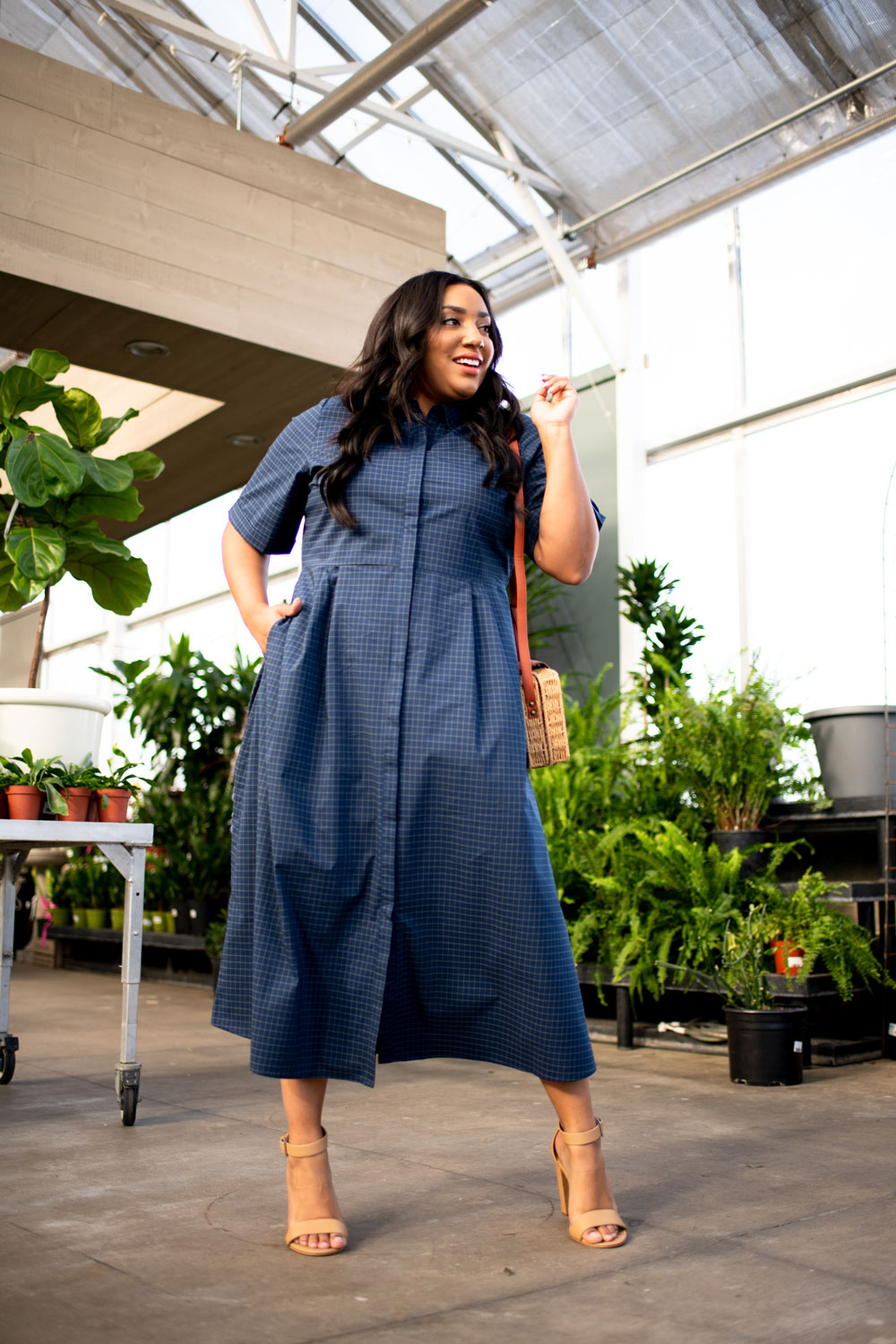 Woman in blue check button down dress