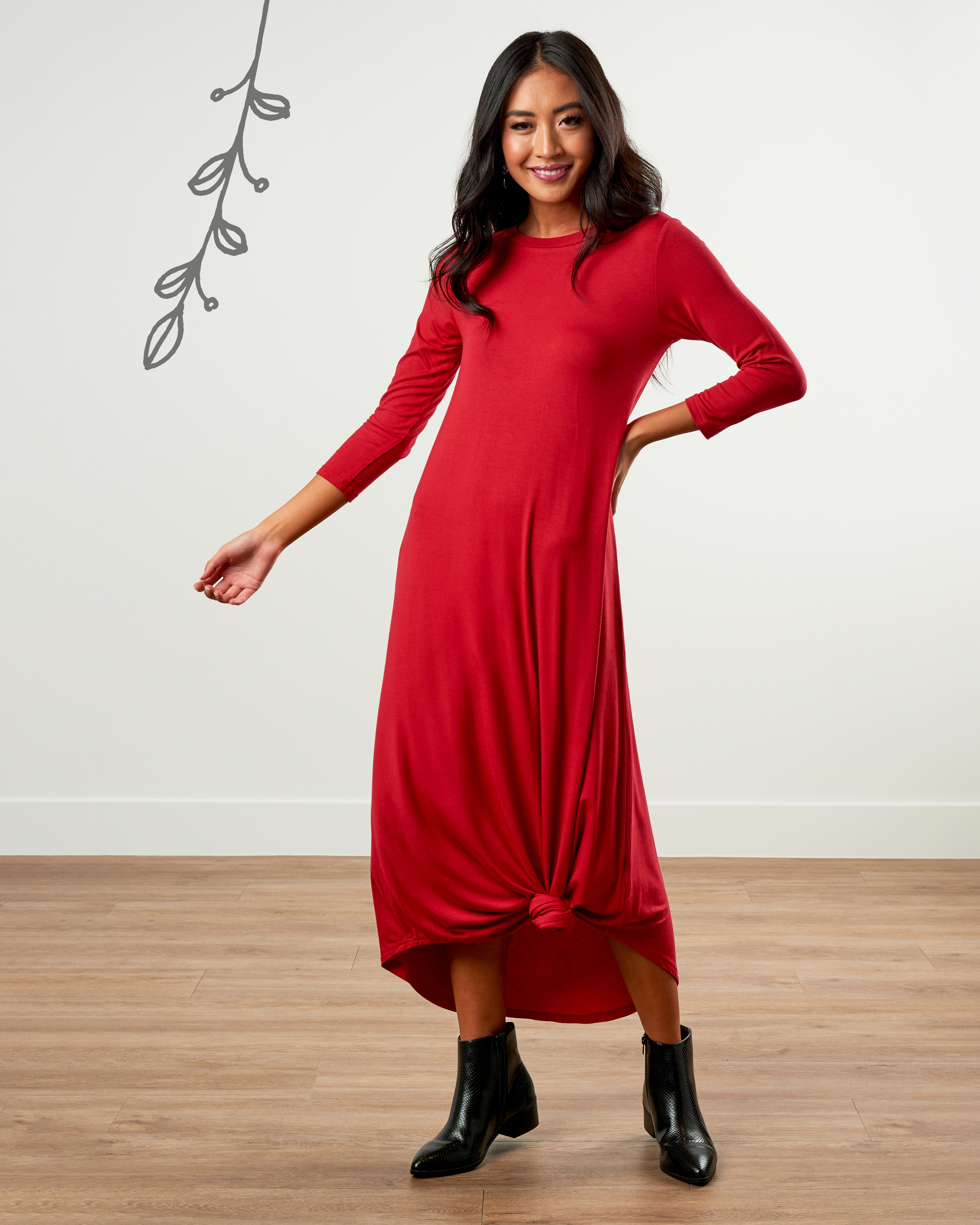 Woman wearing a bold red holiday party dress.