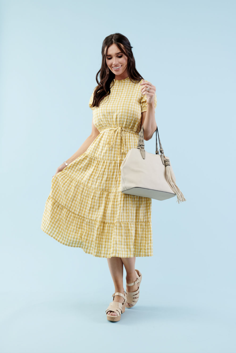 Woman in yellow gingham midi dress